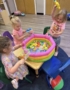 Children playing with toys in inflatable pool bin at crestwood