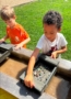 Children panning for rocks in water at crestwood