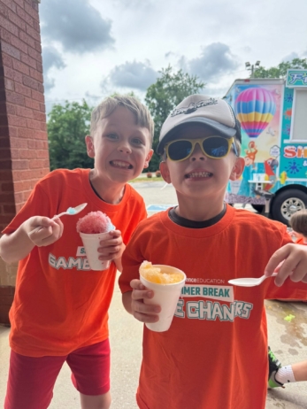 children smiling with snowcones at crestwood