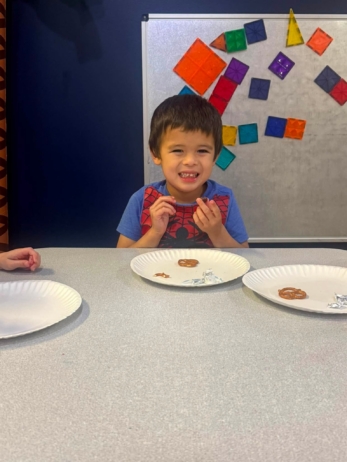 child smiling with snacks at crestwood