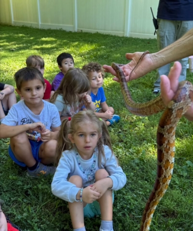 children watching snake being held outside at crestwood