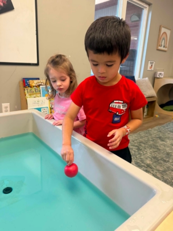 children playing with toys in water at crestwood
