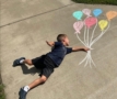 child posing holding onto balloon chalk art at preschool and daycare cadence academy preschool 502 spring hill