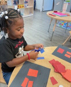 child learning with hands on activity at cadence academy preschool and daycare branch hollow carrollton texas