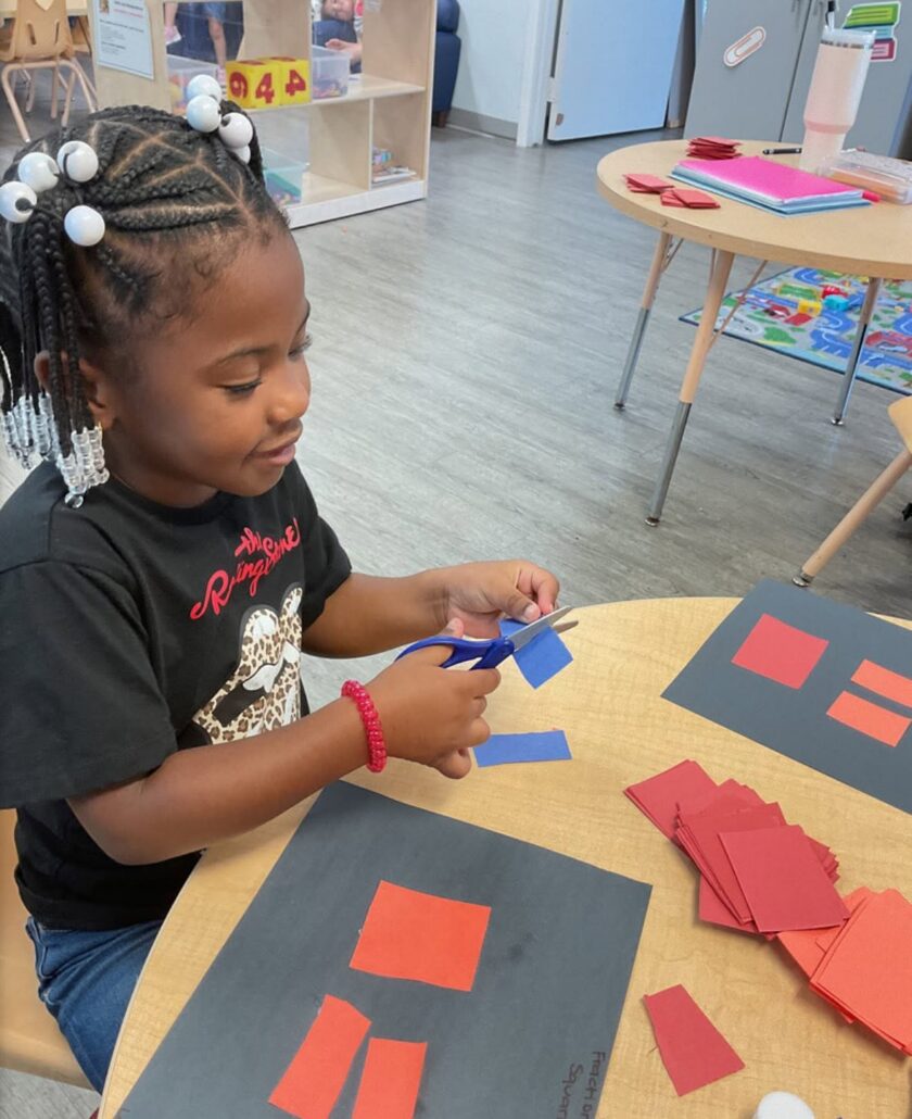 child learning with hands on activity at cadence academy preschool and daycare branch hollow carrollton texas