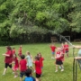 Children running around outside during water time at summer camp at Creative Kids Childcare Centers Beekman