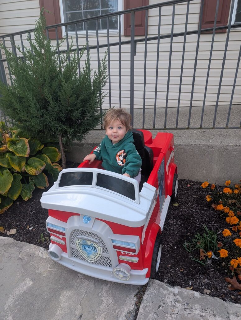 Infant sitting in toy firetruck at Creative Kids Childcare Centers Beekman