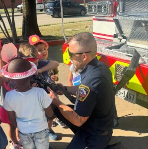children interacting with police officer at cadence academy preschool and daycare branch hollow carrollton texas