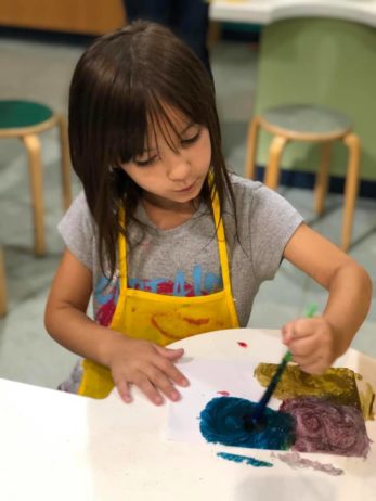 Child doing crafts indoors
