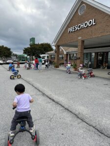 children riding bikes outside of cadence academy preschool and daycare northeast