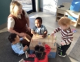 children and teacher playing inside classroom at cadence academy preschool northeast