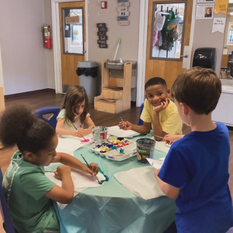 children sitting at desk completing a hands on activity together at cadence academy preschool and daycare mauldin