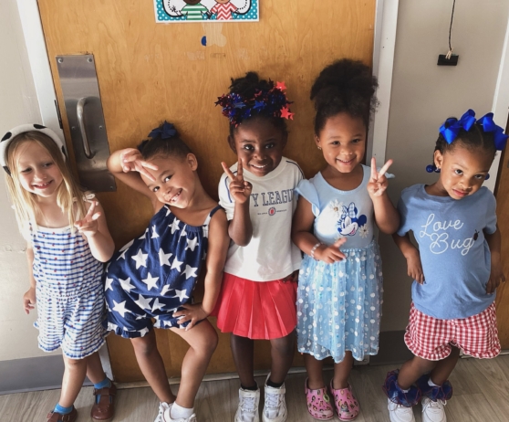 Children posing together against the wall of classroom at cadence education preschool and daycare mauldin