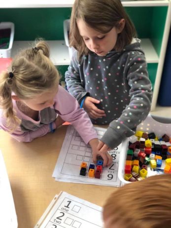 Children doing a a math game indoors