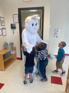Male and Female children hugging easter bunny at Phoenix Children's Academy Private Preschool Surprise 226