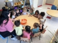 Male and female children interacting and learning with teacher at Phoenix Children's Academy Private Preschool Surprise 226