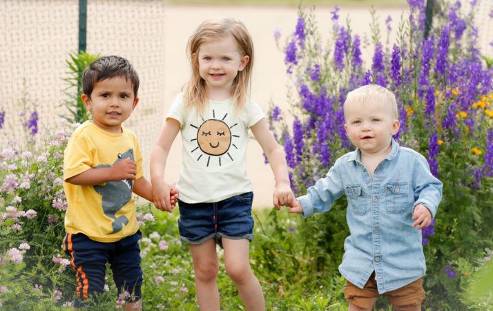 Children smiling in a garden