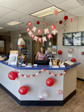 Teacher being celebrated for her birthday at front desk at Phoenix Children's Academy Private Preschool Happy Valley 225
