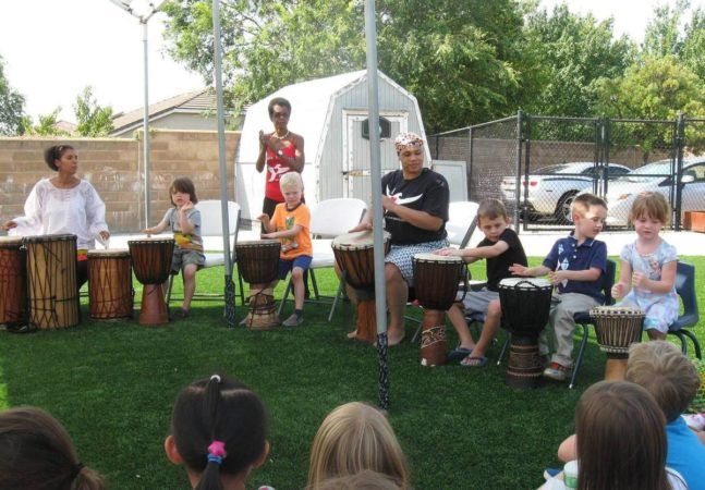 adults_and_children_playing_african_drums_cadence_academy_preschool_roseville_galleria_ca-647x450