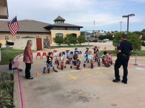 allen_policeman_helps_start_st_jude_trike-a-thon_at_cadence_academy_preschool_allen_tx-603x450