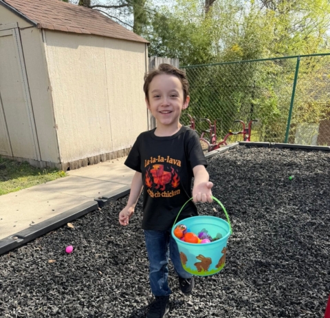 child collecting easter eggs outside on playground at preschool and daycare cadence academy preschool 502 spring hill