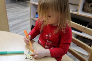 child coloring at table at Cadence Academy Preschool and Daycare Yelm Highway in Olympia, Washington