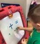 child doing math addition at preschool and daycare at cadence academy preschool smyrna, delaware
