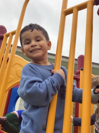 child smiling on outdoor playgrohnd at preschool and daycare cadence academy preschool nolensville 504