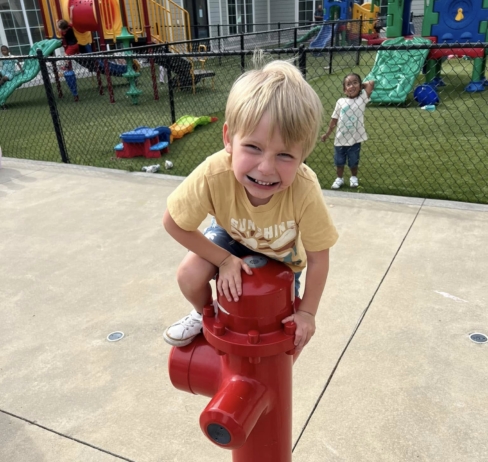Child smiling climbing outside at Cadence academy preschool and daycare 505 murfreesboro