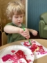 child painting on paper plate with pink paint at preschool and daycare cadence academy preschool nolensville 504