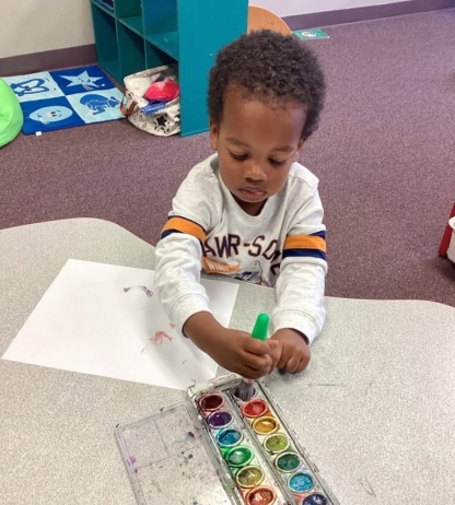 child using watercolor and painting at preschool and daycare at cadence academy preschool smyrna, delaware