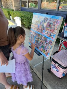 child picking out face paint design at preschool and daycare at cadence academy preschool in the colony texas