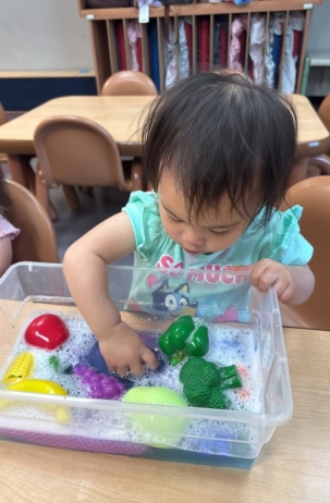 child playing in water for preschool and daycare at cadence academy preschool at boyd's corner in middletown, Deleware