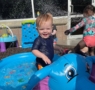 child playing outside in water at preschool and daycare at cadence academy preschool galleria