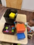 Child putting away blocks in a bin at Cadence Academy Preschool Olive Branch, Mississippi