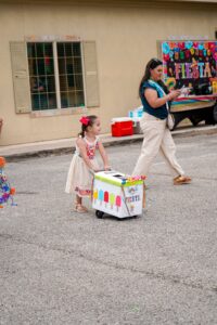 child pushing box at parade at preschool and daycare of 339 wild horse