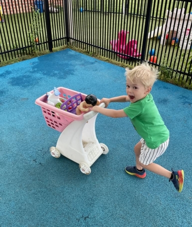 child smiling and running outside at preschool and daycare at cadence academy preschool smyrna, delaware