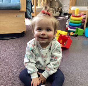 infant smiling and sitting at preschool and daycare at cadence academy preschool smyrna, delaware