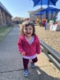 child smiling outside in playground at preschool and daycare at cadence academy preschool in the colony texas
