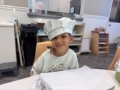 child smiling while cooking