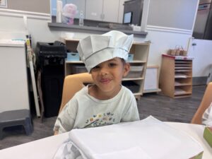 child smiling while cooking