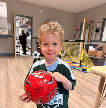 child smiling with soccer ballat preschool and daycare in grapevine texas