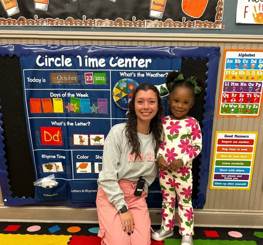 child smiling with teacher at preschool and daycare at cadence academy preschool forney, texas
