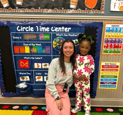 child smiling with teacher at preschool and daycare at cadence academy preschool forney, texas