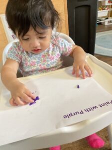 child with purple paint at preschool and daycare at 365 cypress