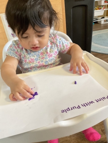 child with purple paint at preschool and daycare at 365 cypress