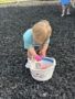 child collecting easter eggs outside on playground at preschool and daycare cadence academy preschool 502 spring hill