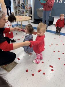 children holding teachers hand during valentines day at cadence academy preschool and daycare raintree in charlotte, north carolina