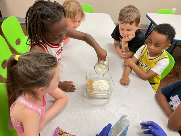 Children doing group hands on learning at preschool and daycare at Cadence Academy Preschool Olive Branch, Mississippi