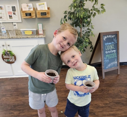 Children smiling and posing together with hands on activity at Cadence academy preschool and daycare 505 murfreesboro